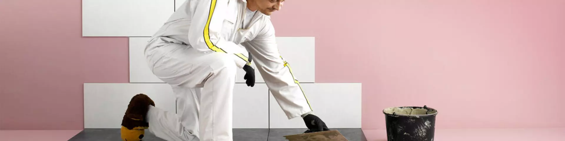 Construction worker applying adhesive